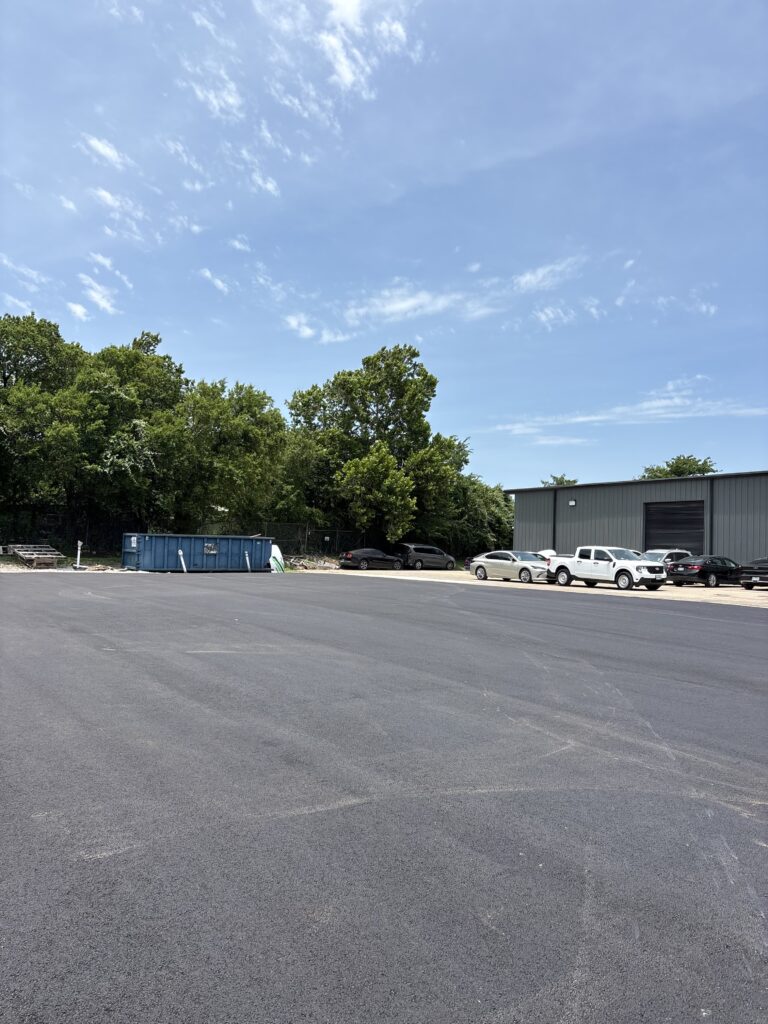 Paved asphalt parking lot beside a commercial building