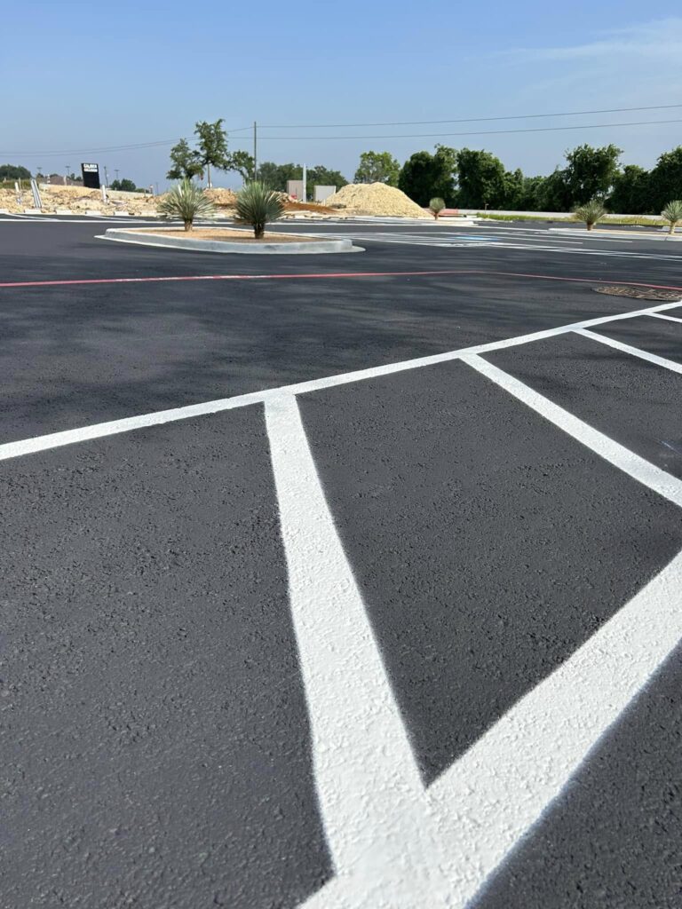 White parking lines mark a freshly paved lot