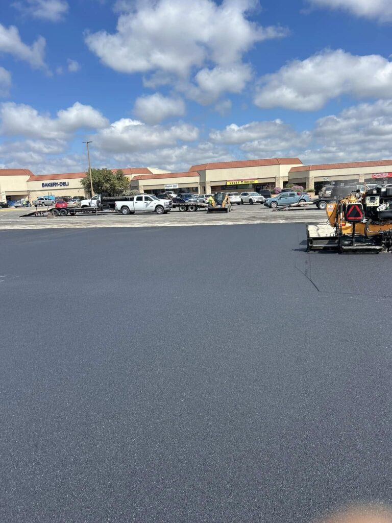 Paving crew works in a shopping center parking lot