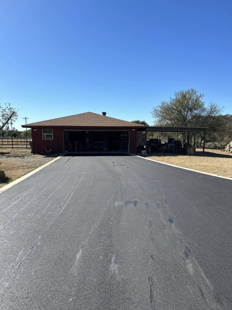 Newly paved driveway leads to a single-story home